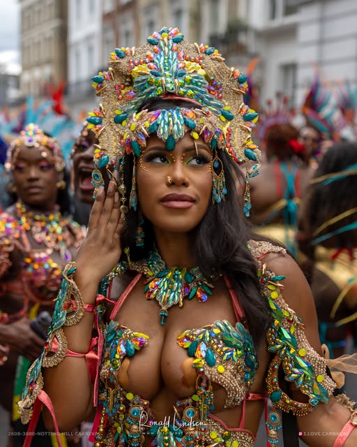 Islandmas masquerader in a jewelled turquoise and gold costume